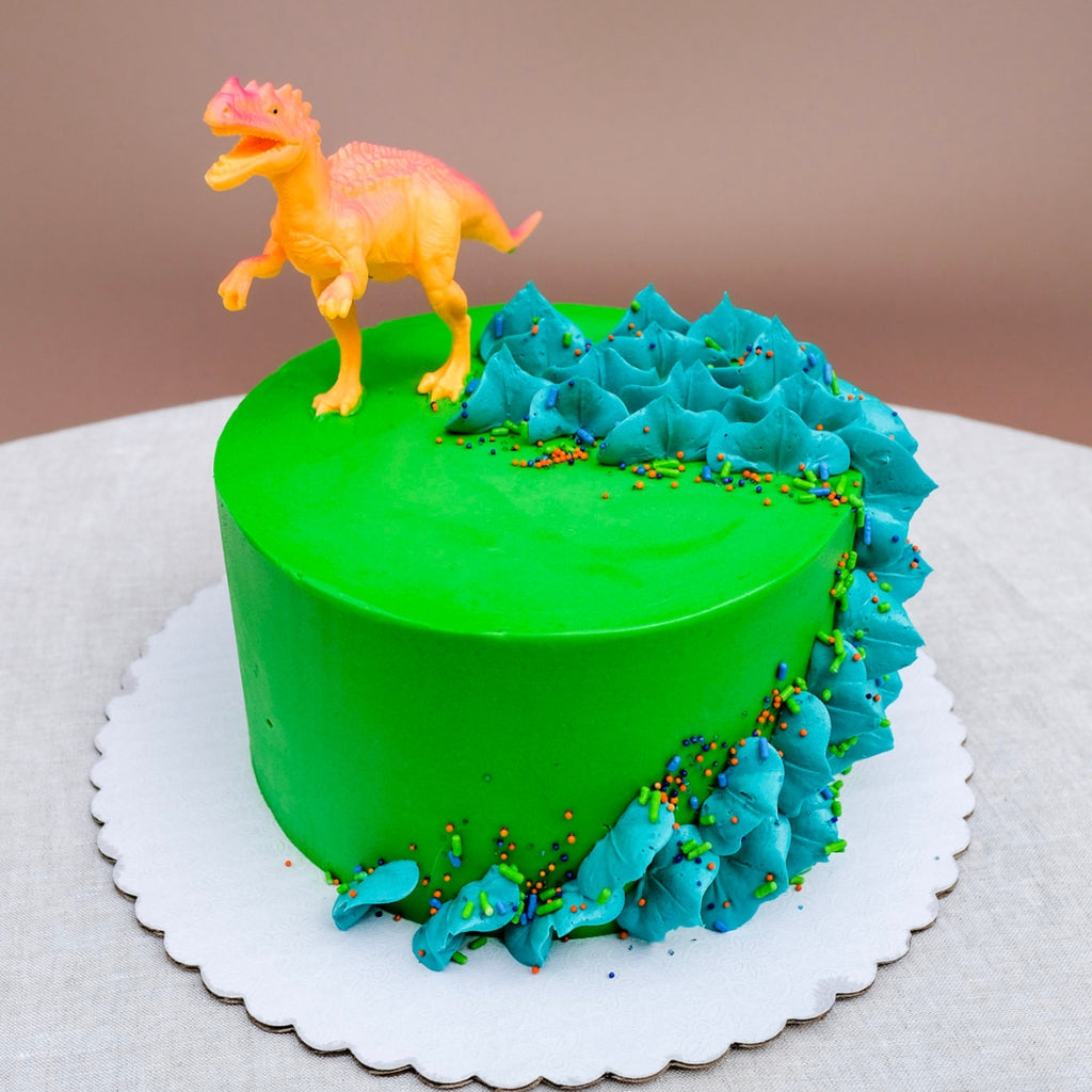 A two tiered dinosaur cake