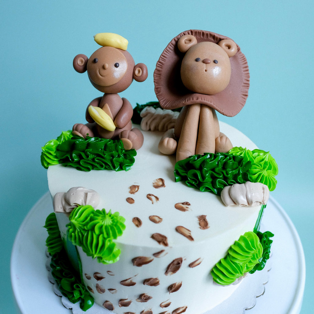 Safari Cake decorated with a Monkey and Lion. 
