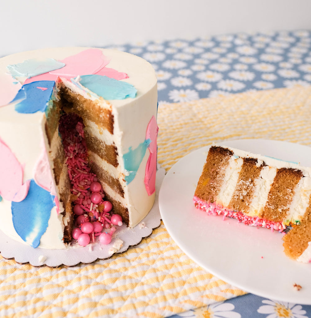 Blue and pink swatch gender reveal cake with pink sprinkles inside