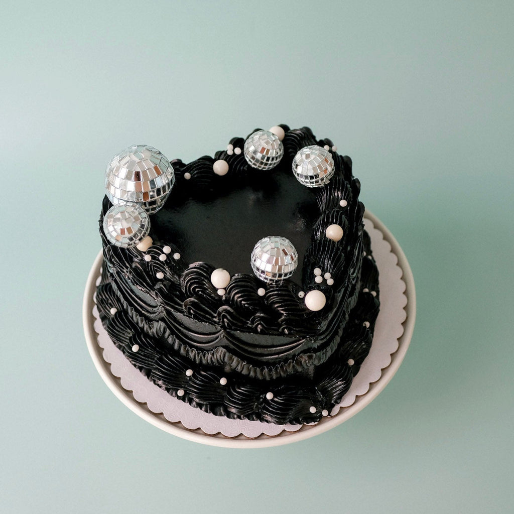 Vintage heart shaped ornate cake with pearls and disco balls
