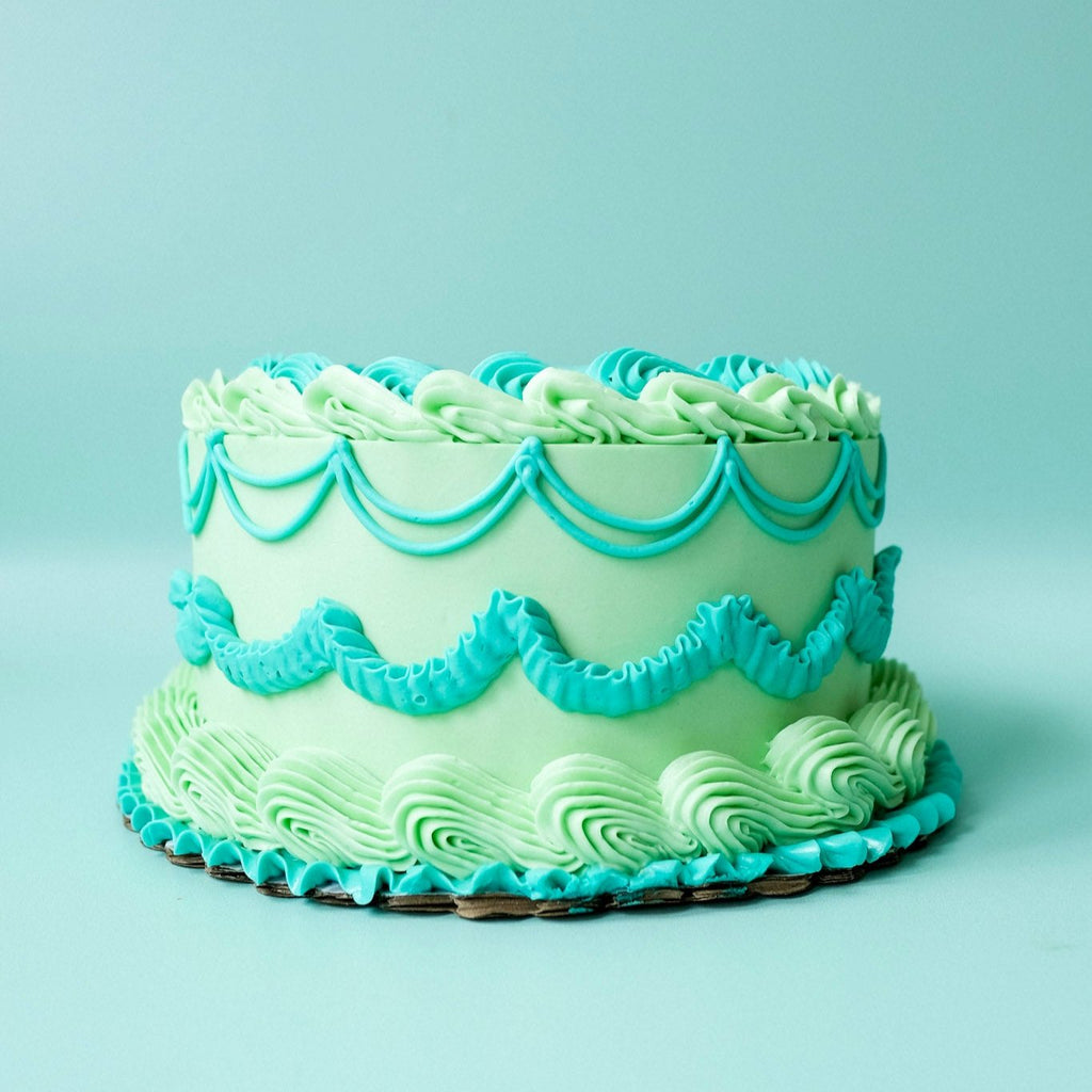 Round ornate astrology cakes, One teal and green.