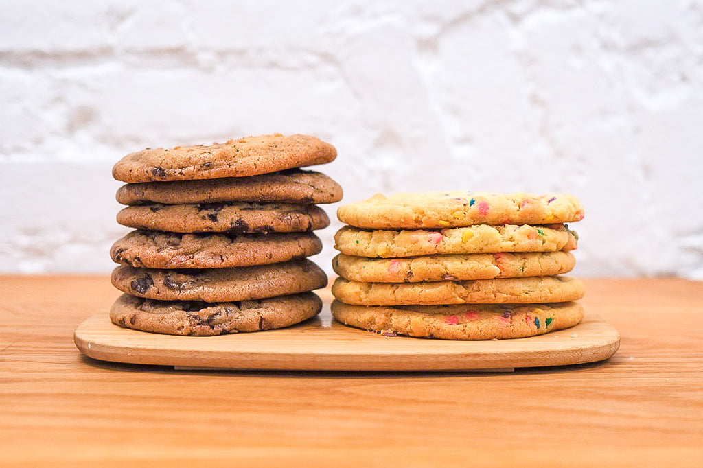 two stacks of chocolate chip and funfetti cookies 