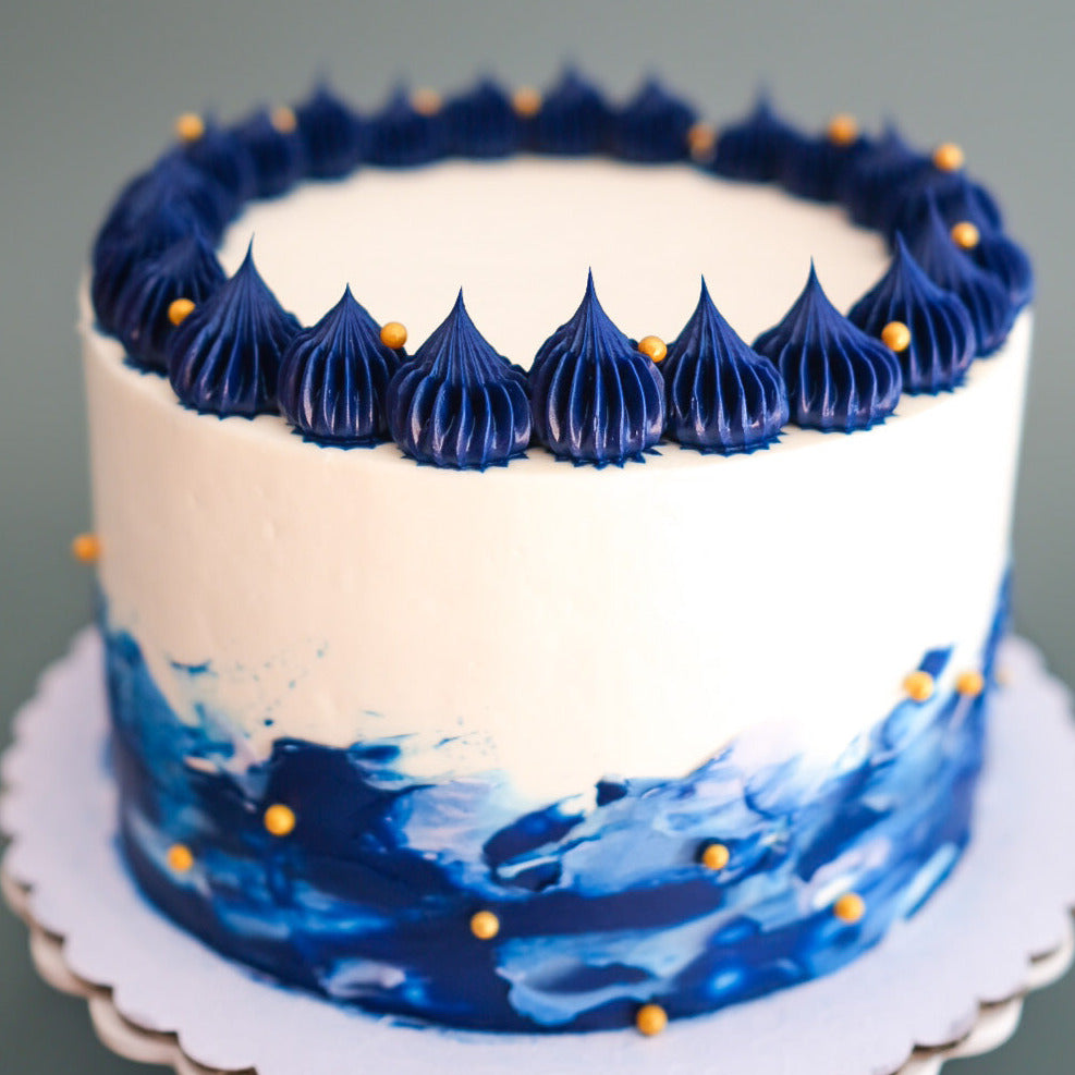 royal blue and white cake with cold sprinkles
