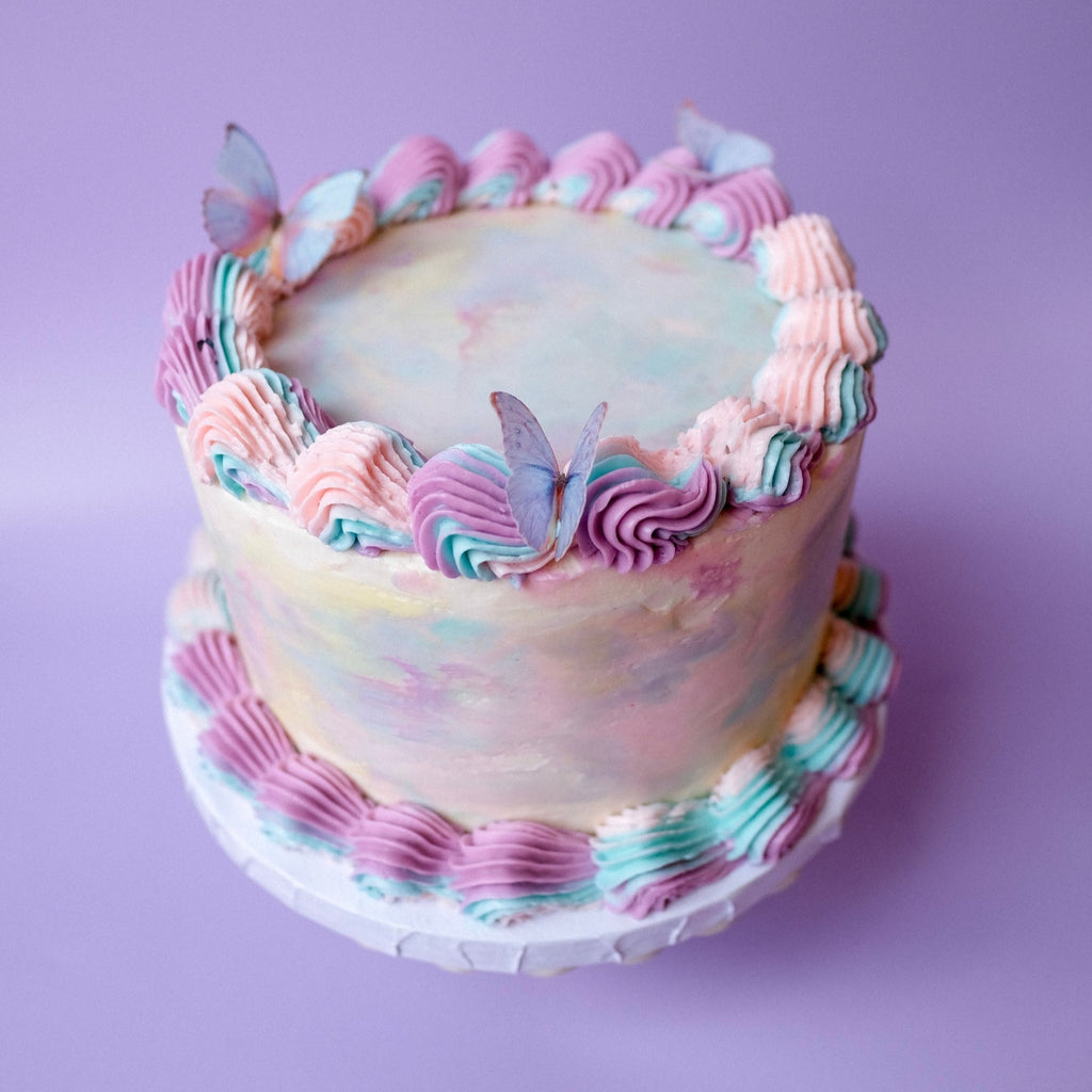 Ornate tie dye cake with butterflies 