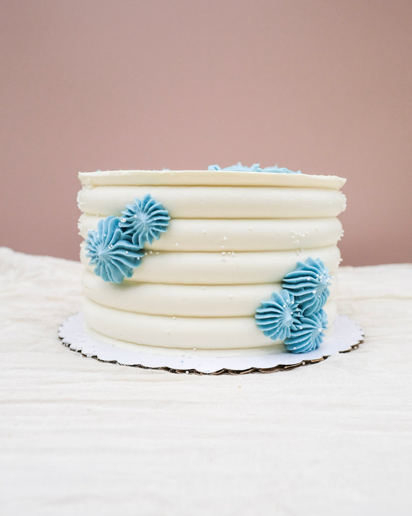 blue rosary bead baptism cake with white sprinkles 