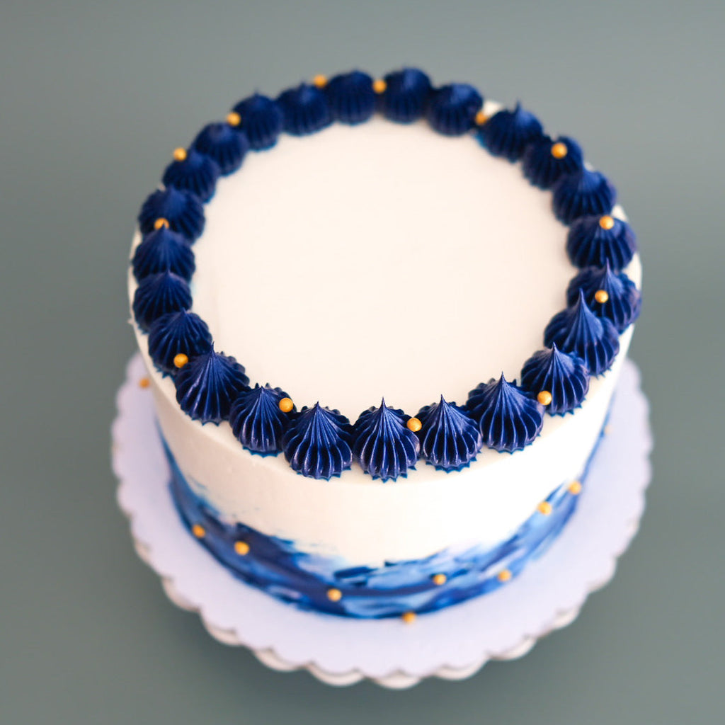 royal blue and white cake with cold sprinkles