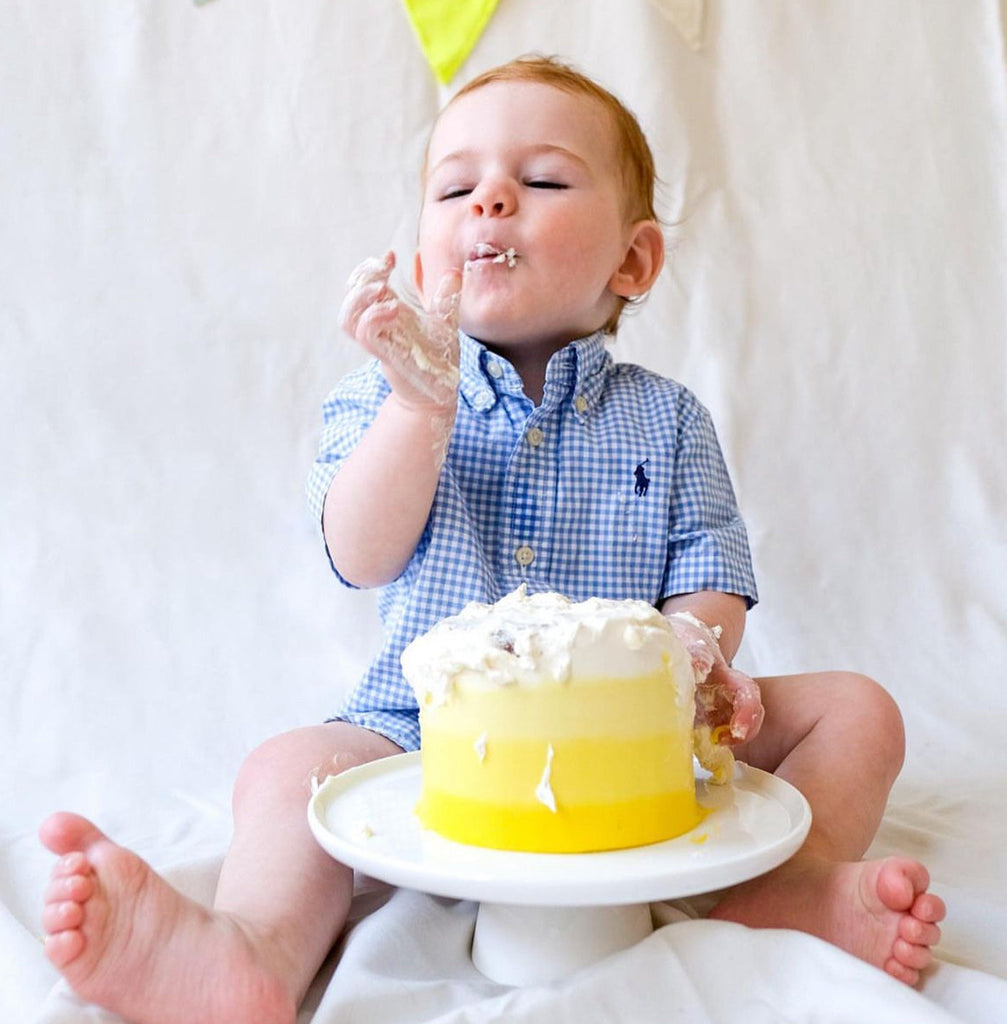 Yellow ombre cake and a one year old boy smashing 