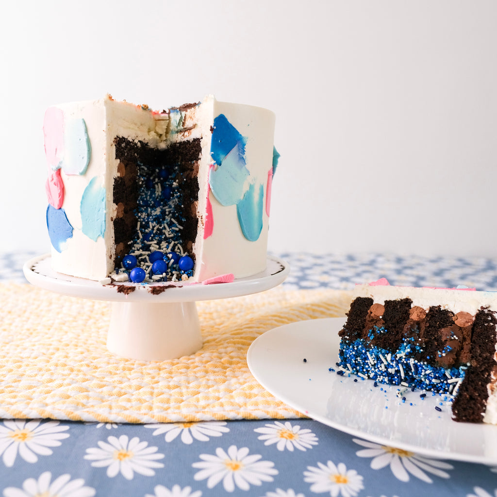 Blue and pink swatch gender reveal cake with blue sprinkles inside