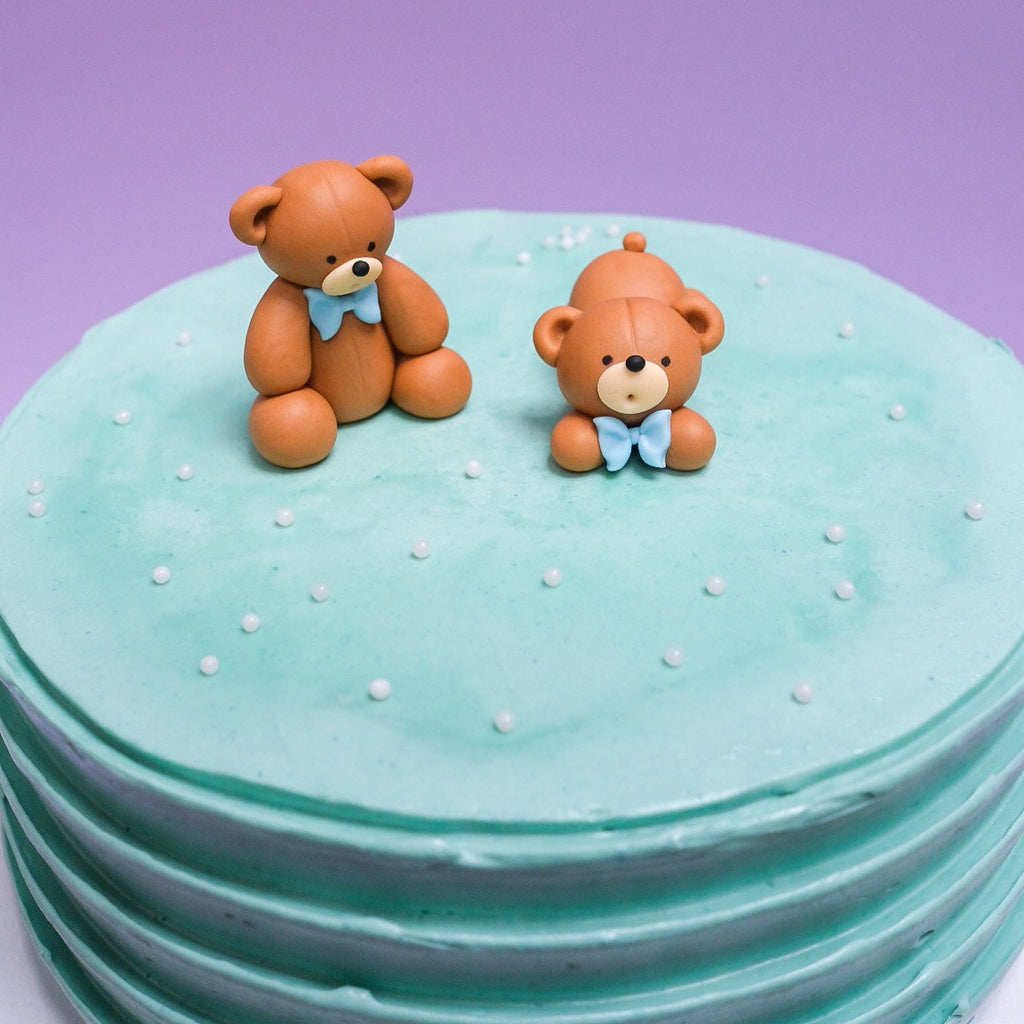light blue bear cake with white sprinkles 