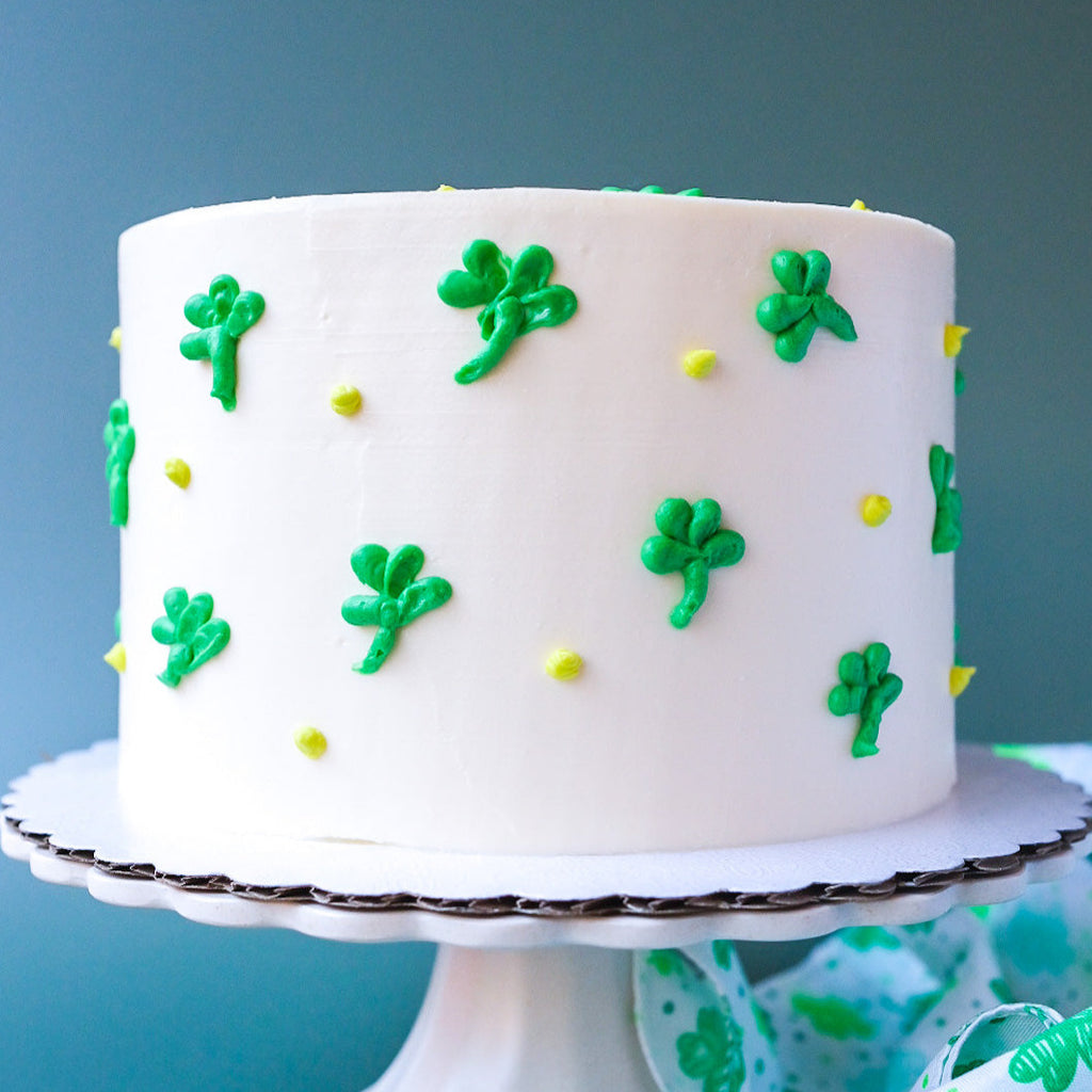 White cake decorated with green clovers