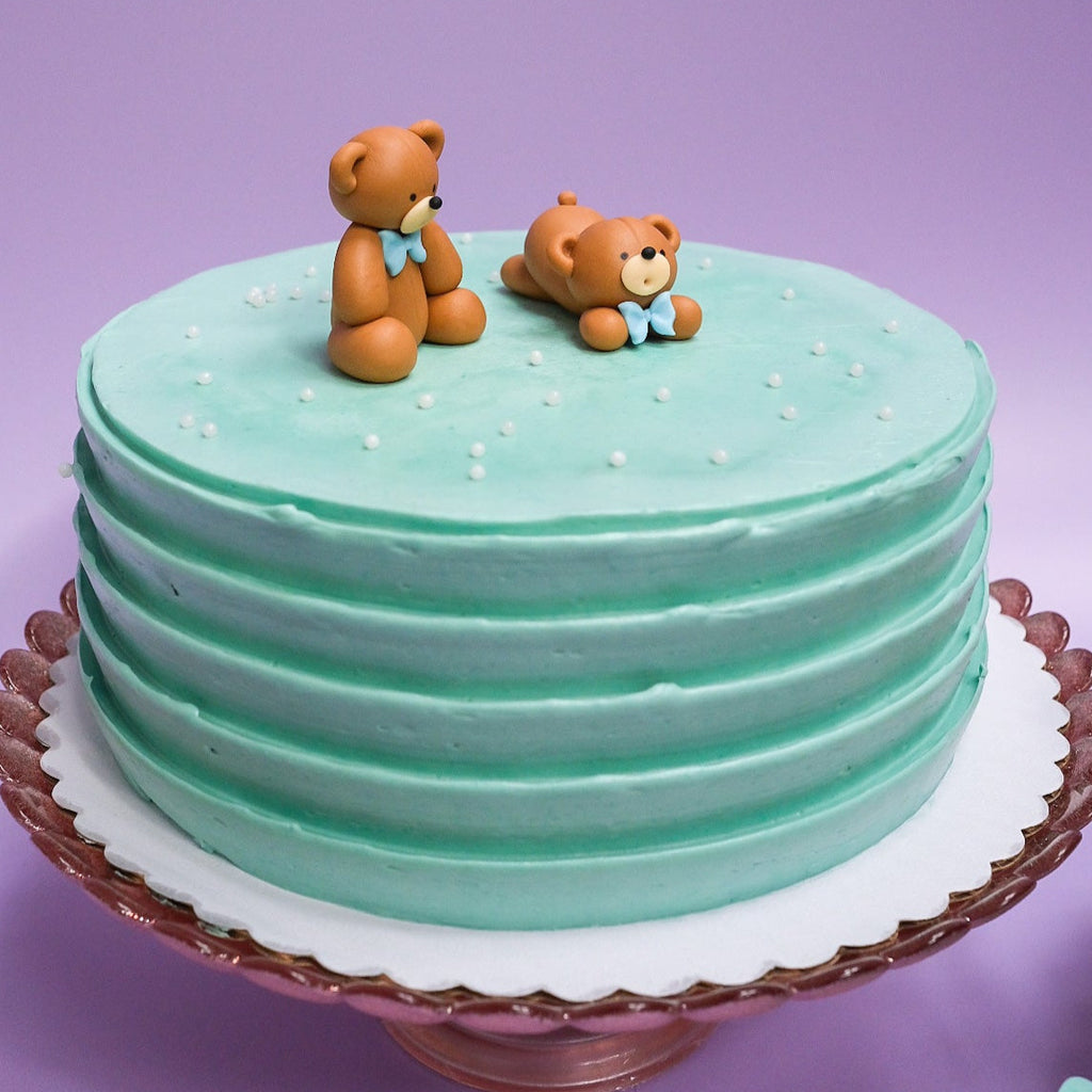 light blue bear cake with white sprinkles 