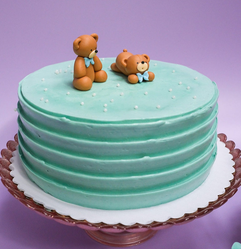 light blue bear cake with white sprinkles 