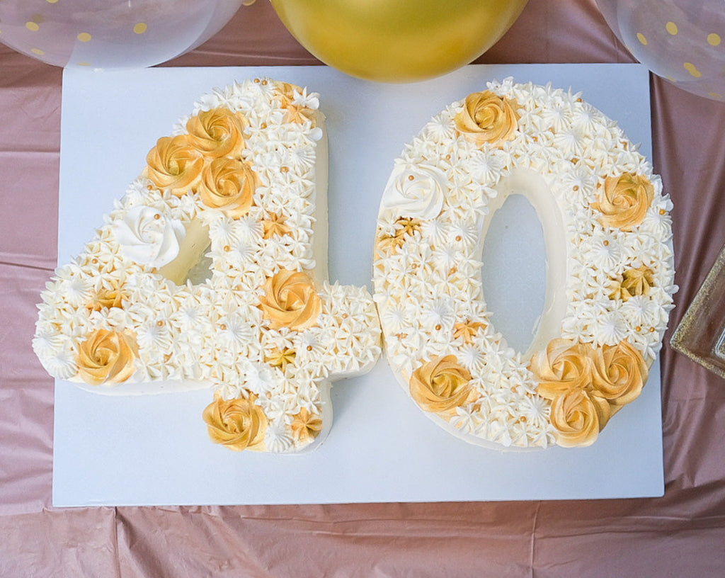 a number 40 white and gold cake 