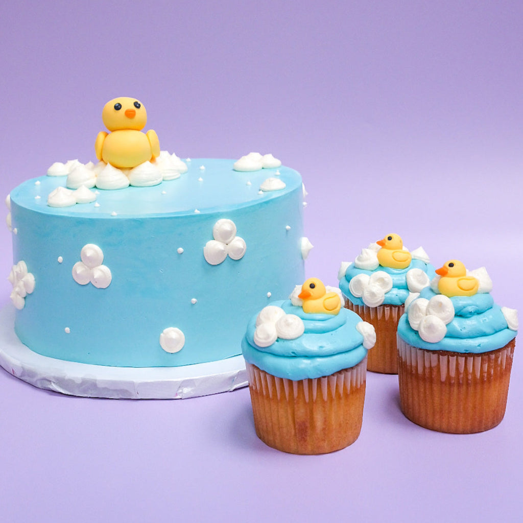 A blue rubber duck cake and cupcakes 