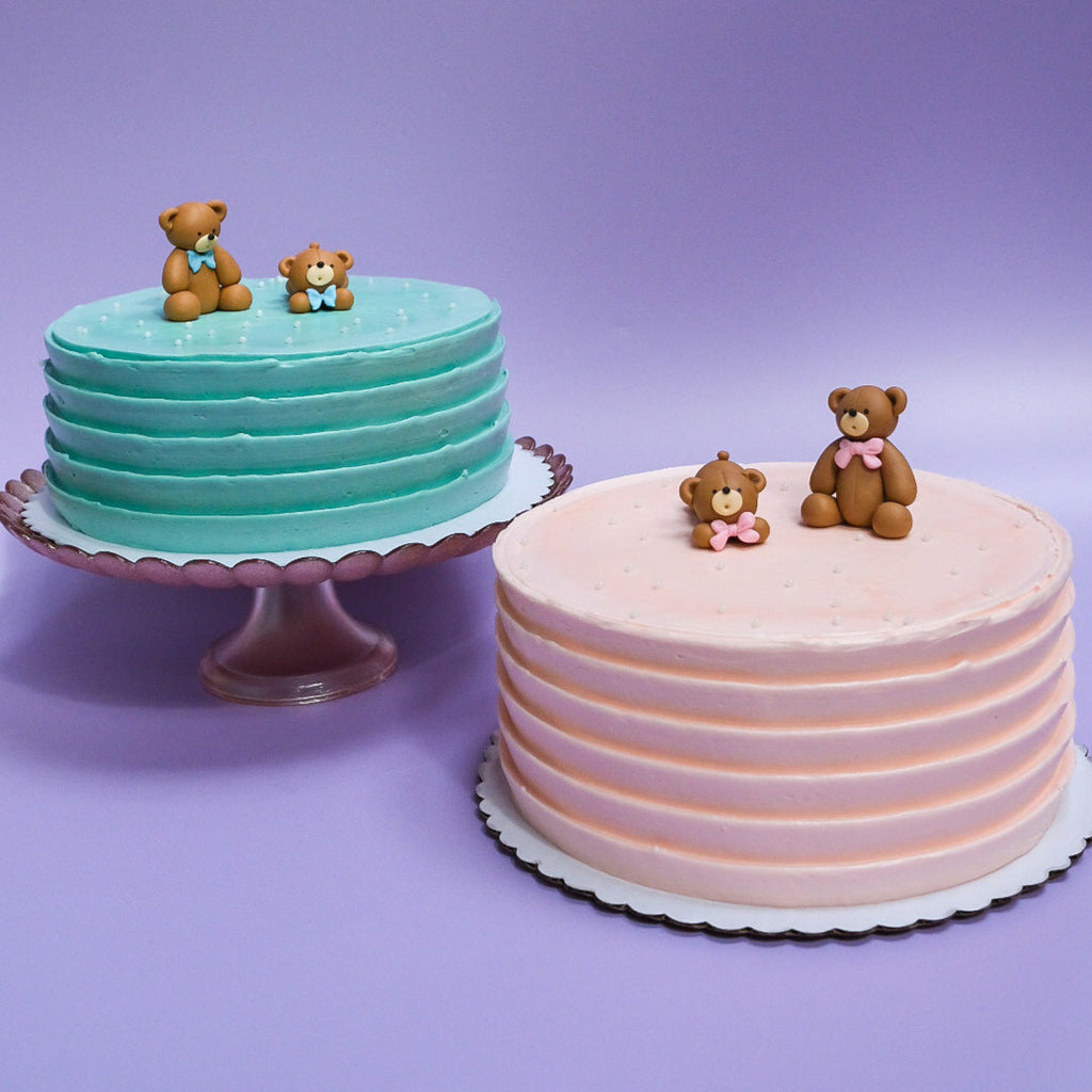 light blue bear cake with white sprinkles and a light pink bear cake with white sprinkles