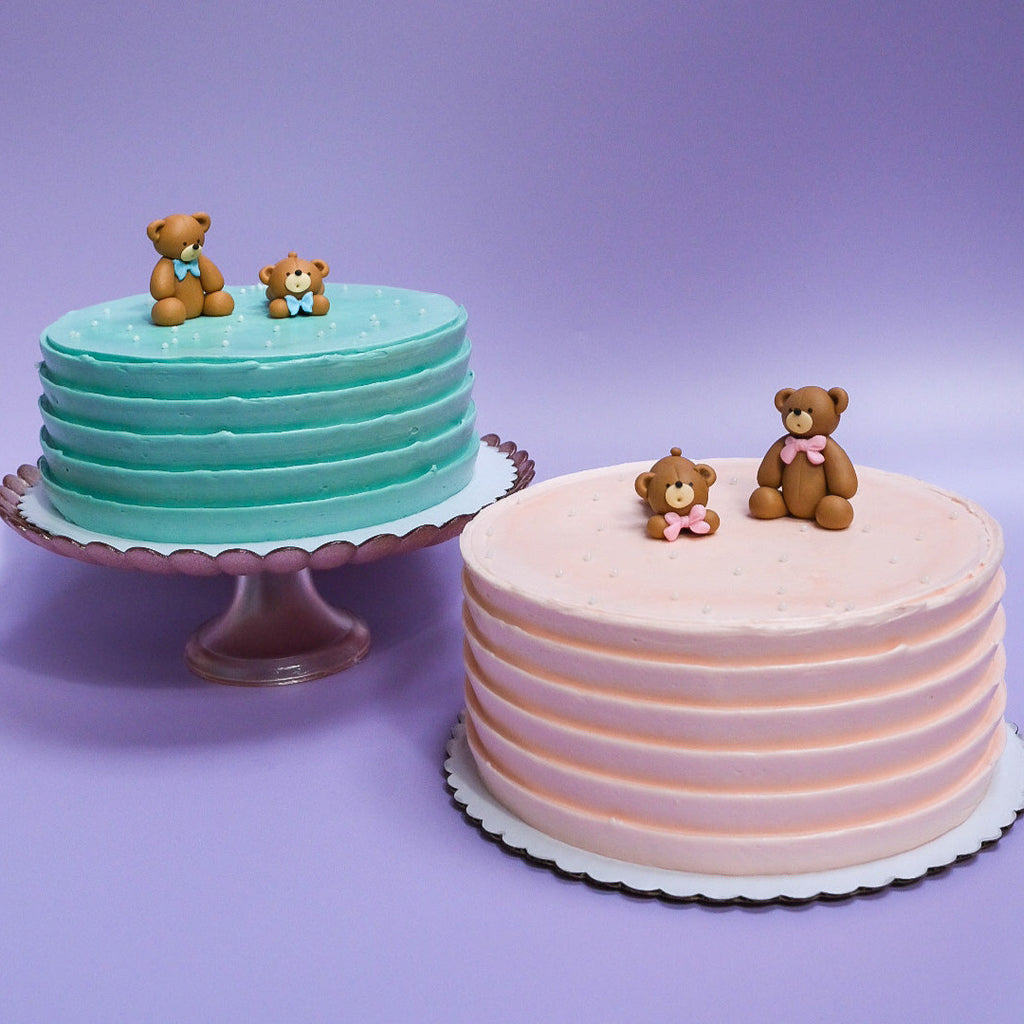 light blue bear cake with white sprinkles and a light pink bear cake with white sprinkles
