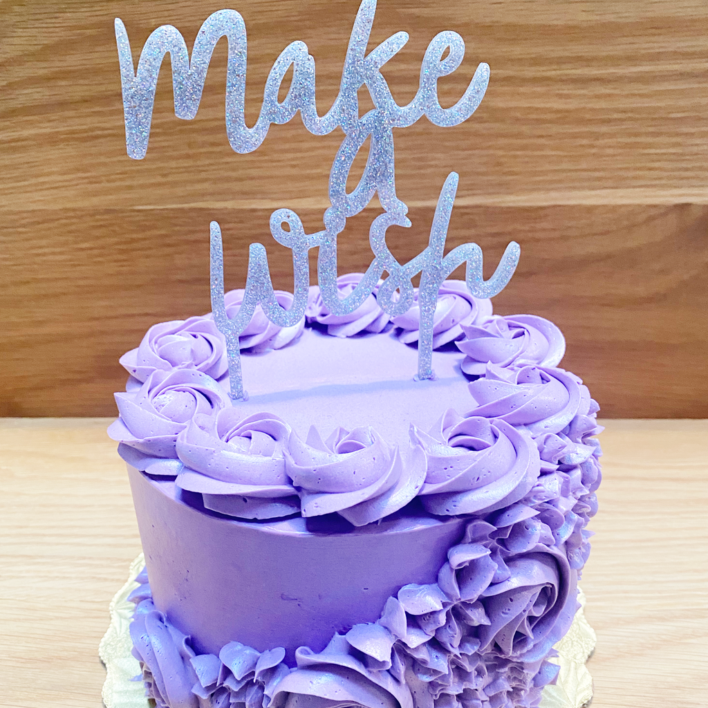 Purple cake with flower rosettes 