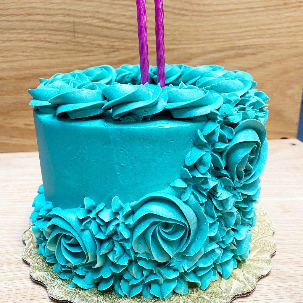 Teal cake with flower rosettes 