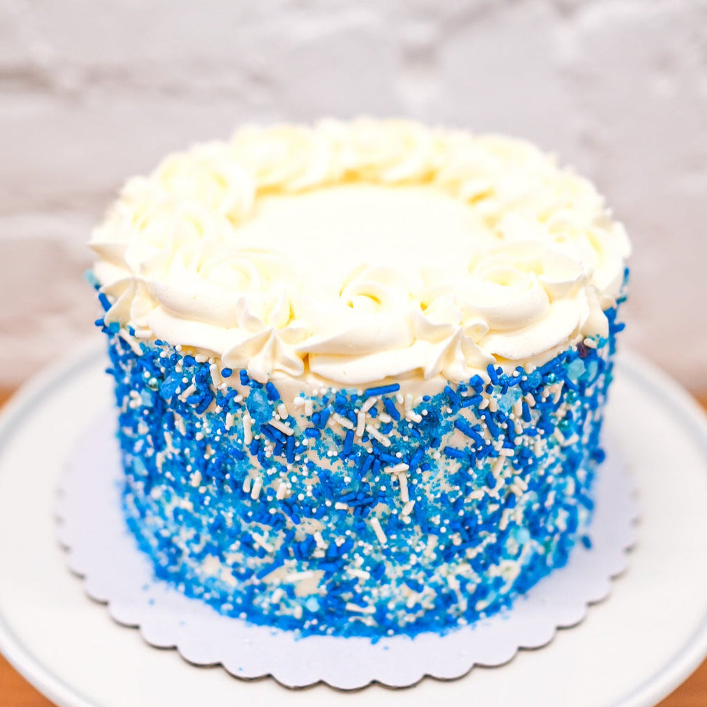 Blue sprinkle cake with white rosettes 