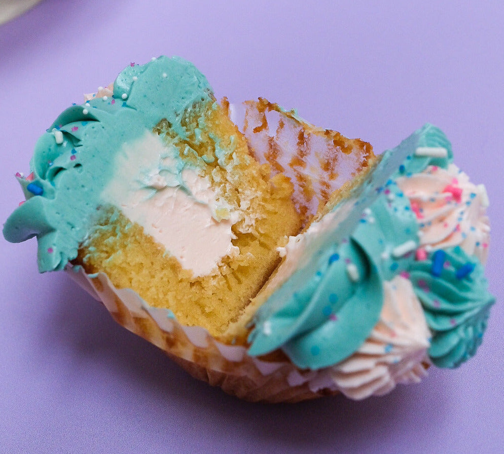 Pink and blue gender reveal cupcakes sliced open