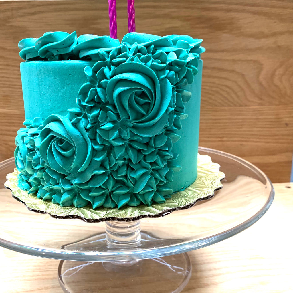 Teal cake with flower rosettes 